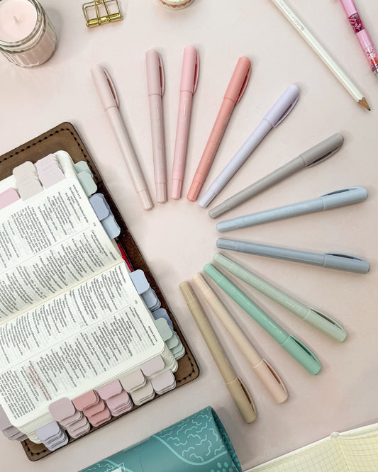 Pastel highlighters shown next to a Bible marked with matching pastel mini tabs