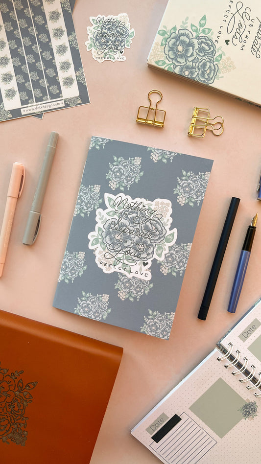 Blue Christian prayer journal notebook featuring a blue floral design & Hand-lettering inspired by Romans 8:38-39 on the cover