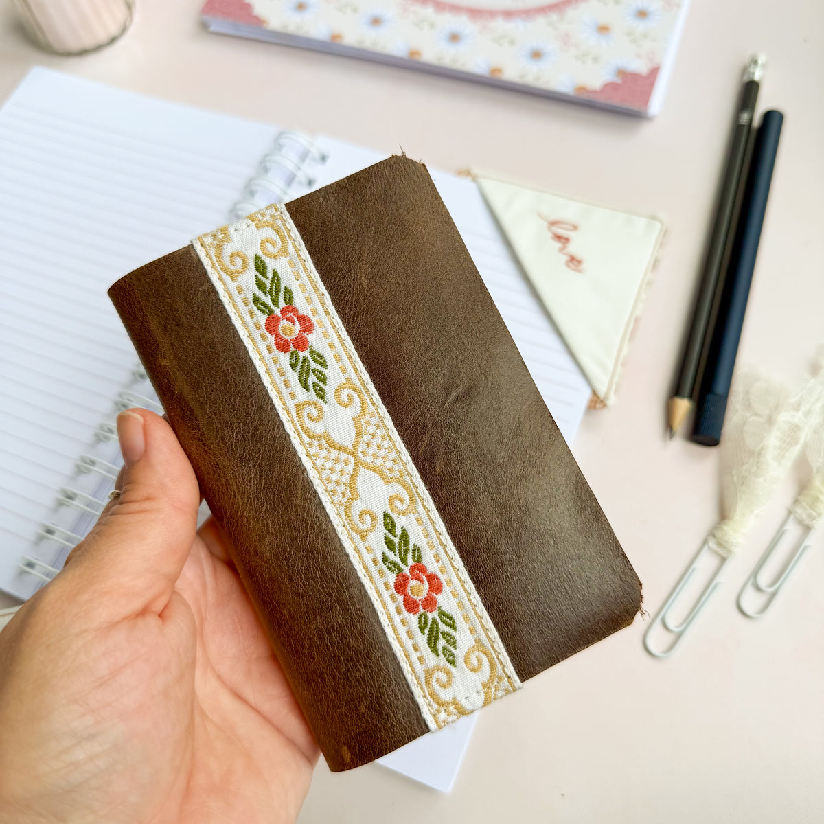 Pocket Bible with brown leather cover and woven floral trim