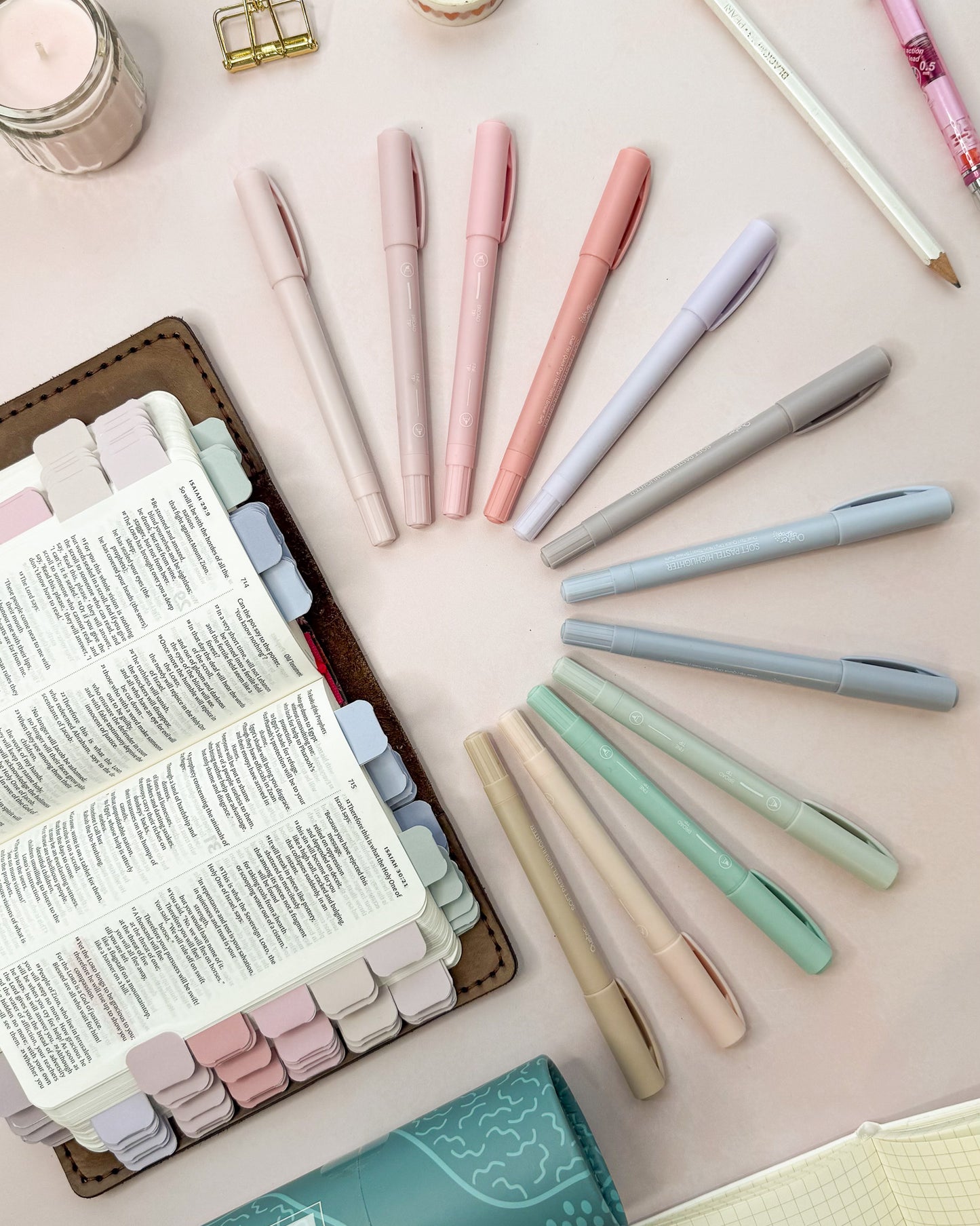 Pastel highlighters shown next to a Bible marked with matching pastel mini tabs
