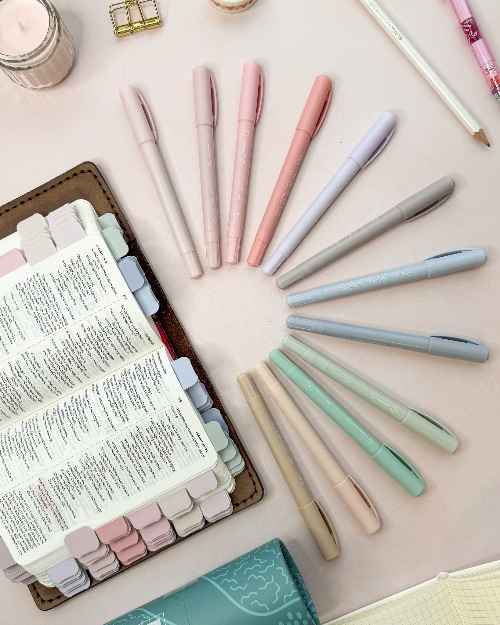 Pastel highlighters shown next to a Bible marked with matching pastel mini tabs
