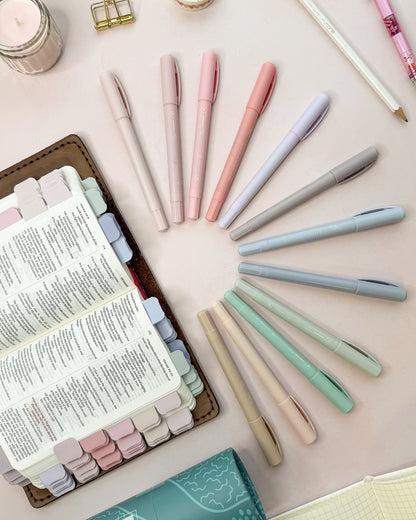 Pastel highlighters shown next to a Bible marked with matching pastel mini tabs
