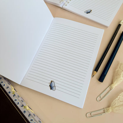 DotK a5 lined journal featuring a butterfly design at the base of each page