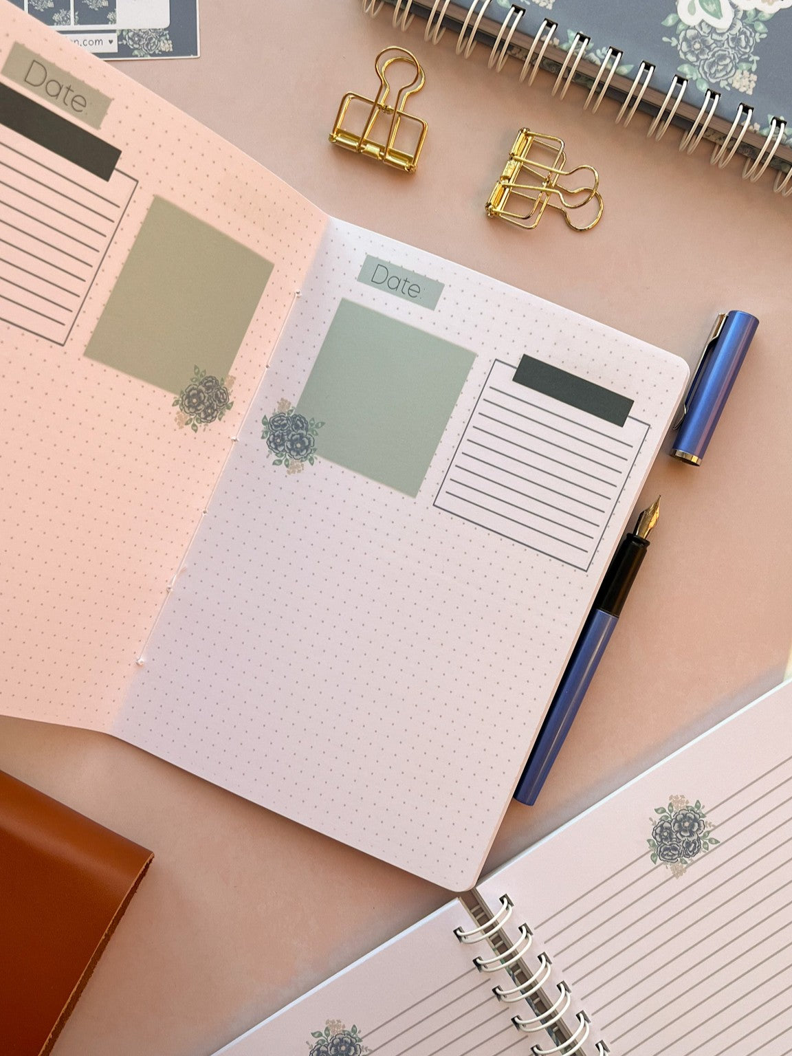 Open Christian prayer journal notebook featuring Dot grid pages with sections and blue floral accents at the base of each page.