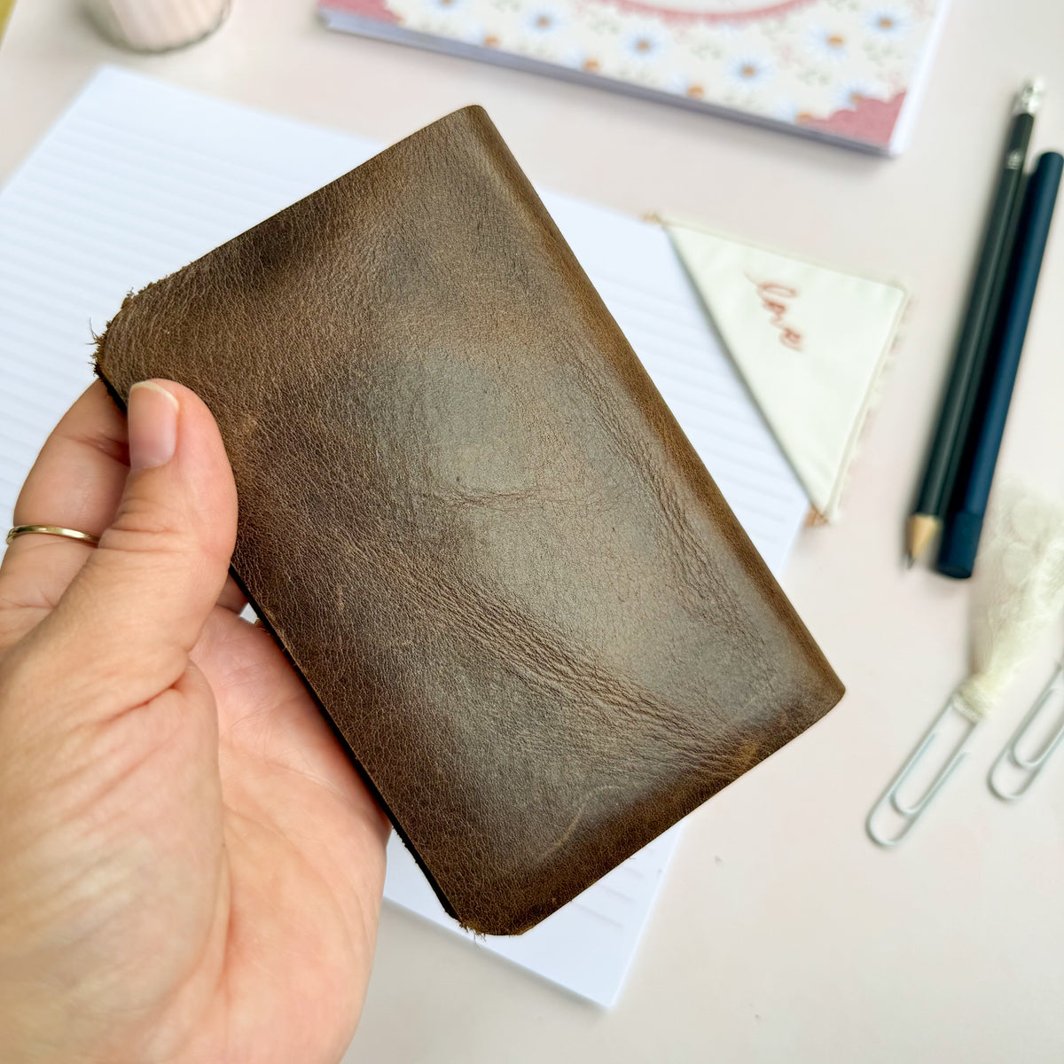 Pocket Bible with brown leather cover and woven floral trim