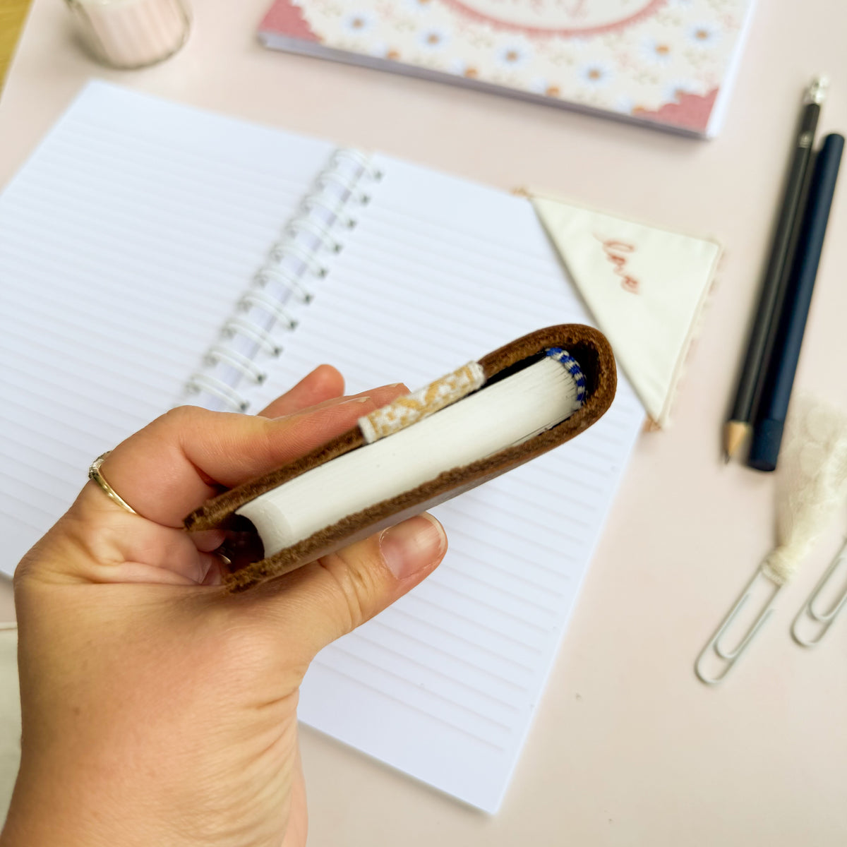 Pocket Bible with brown leather cover and woven floral trim