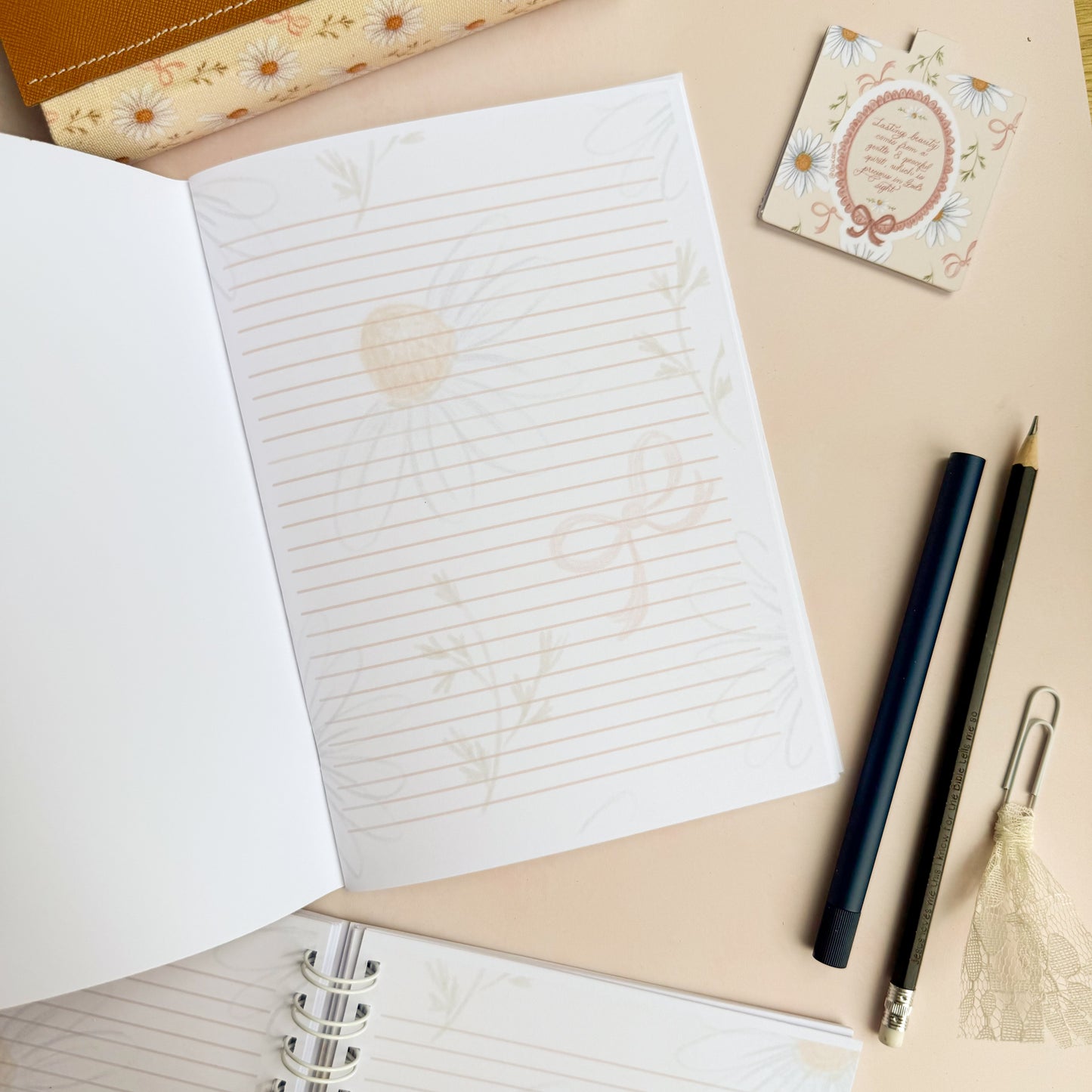 Wirebound notebook with daisies and bows, with a hand lettered excerpt from 1 Peter 3:3-4