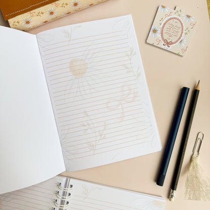 Wirebound notebook with daisies and bows, with a hand lettered excerpt from 1 Peter 3:3-4