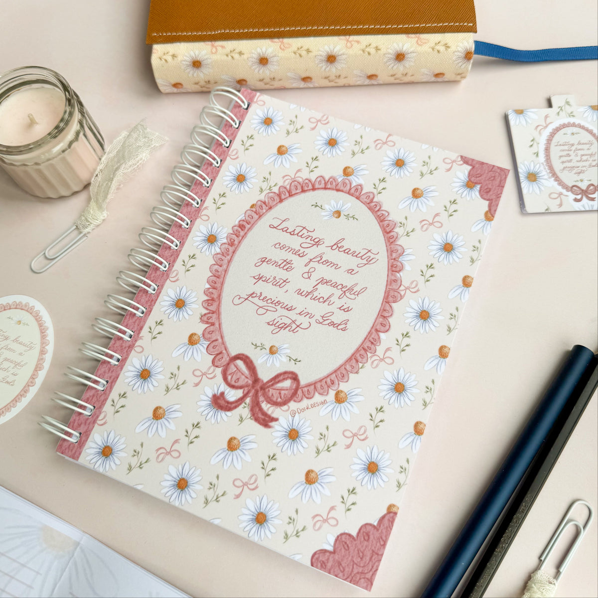 Wirebound notebook with daisies and bows, with a hand lettered excerpt from 1 Peter 3:3-4