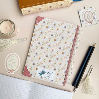 Wirebound notebook with daisies and bows, with a hand lettered excerpt from 1 Peter 3:3-4